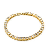 Detailed close-up of a golden tennis bracelet with round clear cubic zirconia stones
