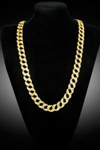 Detail of gold Cuban link necklace with sparkling stones on a black bust mannequin