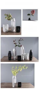 Detailed view of matte ceramic vases with creative Nordic facial design in black and white