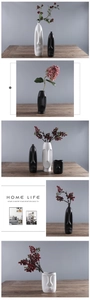 Detailed macro view of matte black and white ceramic face vases with smooth textures