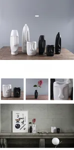 Detailed relief of abstract facial features on a minimalist matte ceramic vase design