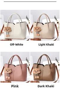 Detail view of small bucket bag in four colors with plush cloud charm and lychee leather