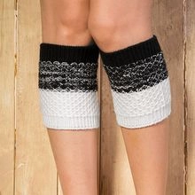 Detail of tricolor knitted leg warmers in black, grey and white on a model