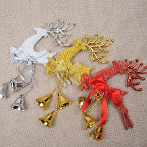Close-up of three reindeer ornaments with bells and ribbons on a burlap background
