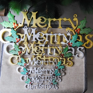 Detail of glittery gold and silver Merry Christmas hanging ornaments on burlap cloth