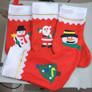 Set of four red and white felt Christmas stockings with Santa and snowman patterns