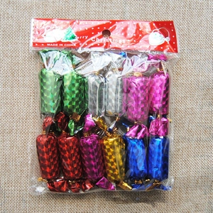 Detail of candy-shaped Christmas ornaments in metallic colors and laser texture finish