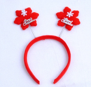 Detail of red Merry Christmas headband with white snowflakes and festive springs