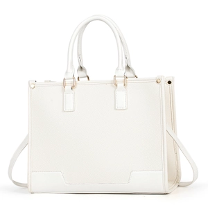 Close-up of white pebble leather tote bag featuring gold hardware and removable shoulder strap