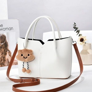 White lychee leather tote bag with brown straps and cute cloud plush charm detail