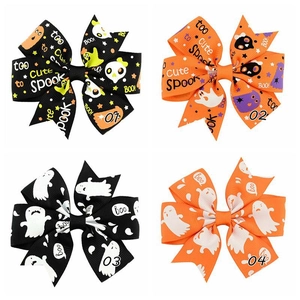 Detail of four Halloween bows in black and orange ribbon with Boo pattern and text