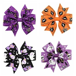 Detailed view of four Halloween themed grosgrain ribbon bows with spider and ghost prints