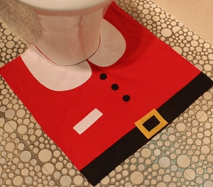 Detail of red Santa Claus suit toilet rug with black belt and yellow buckle decor