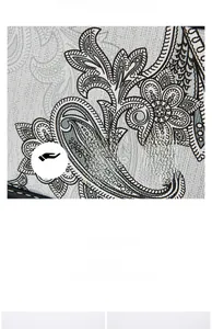 Macro detail of soft paisley pattern fabric showing its delicate texture and light finish