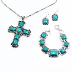 Detailed set of vintage silver alloy jewelry featuring turquoise square and cross pendants
