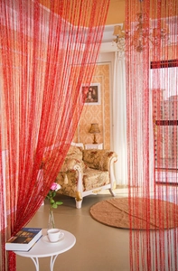 Detail of red glitter string curtain with sparkling silver threads for home decor