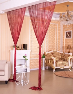 Detail of burgundy glittering thread curtain hanging in a classic living room setting