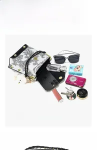 Top view of compact paisley crossbody bag showing inner capacity for phone and camera