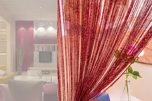 Detail of wine red string curtain with metallic silver threads for room partition decor