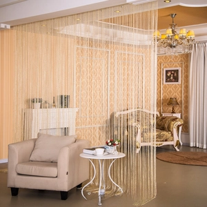 Detail of decorative champagne gold tassel fringe curtain for indoor room separation