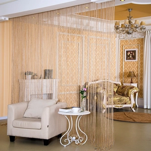 Close-up of golden flat silver wire tassel curtain for elegant room dividers and windows