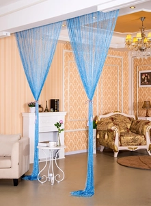 Detail of bright blue tassel string curtain with shimmer effect for room divider decoration