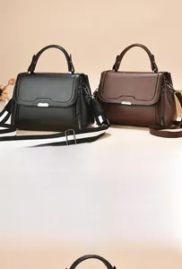 Detail of black and brown minimalist tote bags with woven and leather shoulder straps