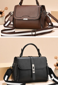 Detail of elegant leather handbags with striped wide strap in brown and black colors