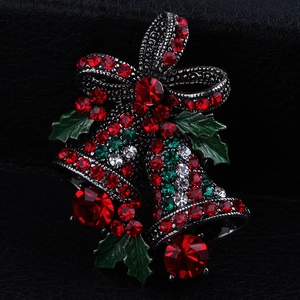 Detailed macro view of Christmas twin bell brooch with red and green rhinestones
