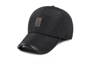Detail view of winter quilted baseball cap with ear flaps and leather brand patch