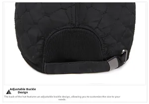 Detail of adjustable metal buckle and elastic band on quilted black winter baseball cap