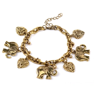 Vintage gold metal elephant and hollow heart charm bracelet on a clean white background
