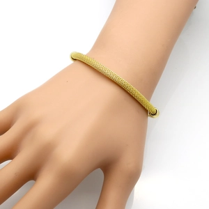 Detailed view of elegant golden stainless steel mesh bracelet worn on wrist model