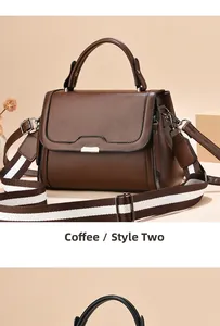 Detail of coffee brown leather crossbody bag with stylish striped woven wide shoulder strap