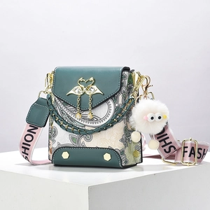 Retro paisley print crossbody bag with green leather trim and gold swan buckle