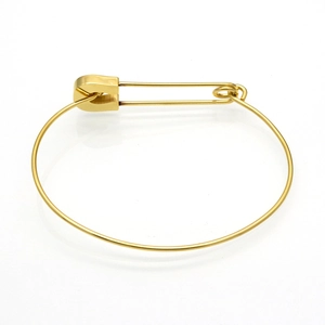 Detailed view of the gold safety pin bracelet with polished titanium steel finish