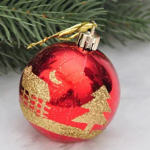 Red shiny Christmas ball with golden winter cedar pattern and silver hanging cap