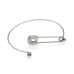 Minimalist silver safety pin bangle in titanium steel with a sleek metallic finish