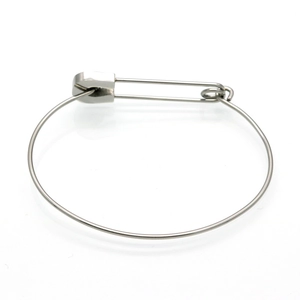 Macro detail of silver safety pin bracelet with polished stainless steel finish