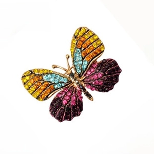Colorful rhinestone butterfly brooch detail showcasing vibrant crystals and gold finish.