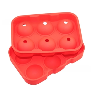 Detail view of a 6-hole red silicone ice ball mold with separate base and top lid