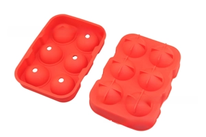 Detail of red food-grade silicone mold for making six large spherical ice balls