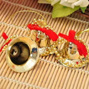 Set of 3 gold Christmas bells with red velvet bows and strings for festive tree decoration