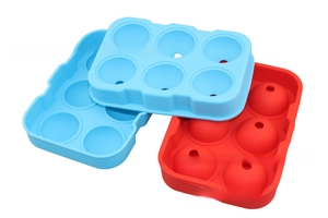 Close-up of red and blue 6-cavity round silicone ice ball molds in stacked display