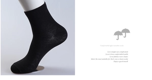 Detail of black cotton business sock on a model showing breathable knitted texture