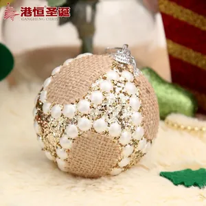 Linen Christmas ball with white pearls and gold glitter on white carpet background