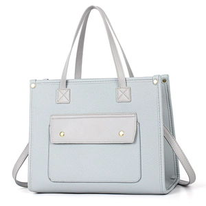Detail of grey-blue pebble leather tote with gold hardware and front flap pocket