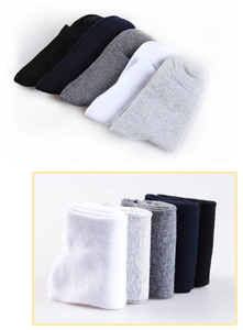 Detail view of five solid color knit cotton crew socks in black, navy, grey and white