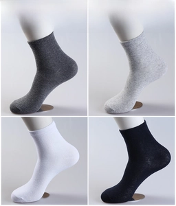 Detail view of cotton crew socks in black, white, and grey with ribbed cuffs