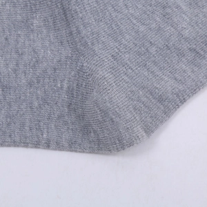 Macro detail of reinforced grey cotton business sock heel showing fine knit texture